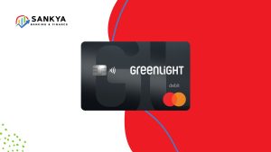 Image of the Greenlight Prepaid Mastercard, a sleek black debit card designed for kids and teens, shown prominently on a modern red and white background with the Sankya Banking & Finance logo in the corner.