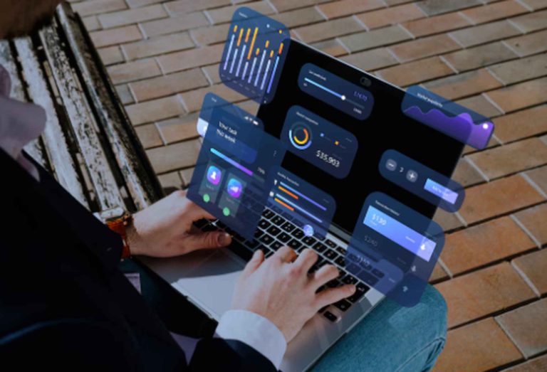 A person working on a laptop outdoors with futuristic financial dashboards projected above the screen, symbolizing the rise of automated investments and digital portfolio management in 2025.