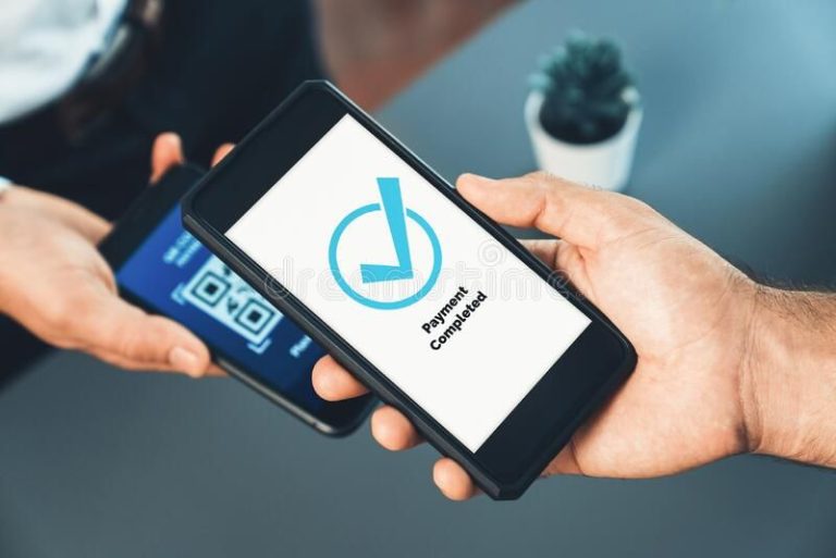 A person holding a smartphone showing “Payment Completed” after scanning a QR code, representing the growing use of instant payments for fast and secure transactions.
