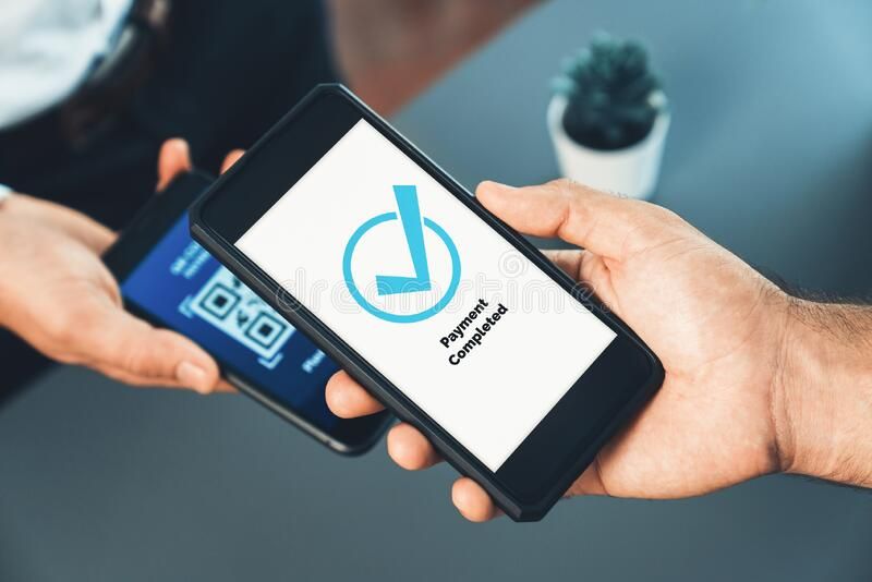 A person holding a smartphone showing “Payment Completed” after scanning a QR code, representing the growing use of instant payments for fast and secure transactions.